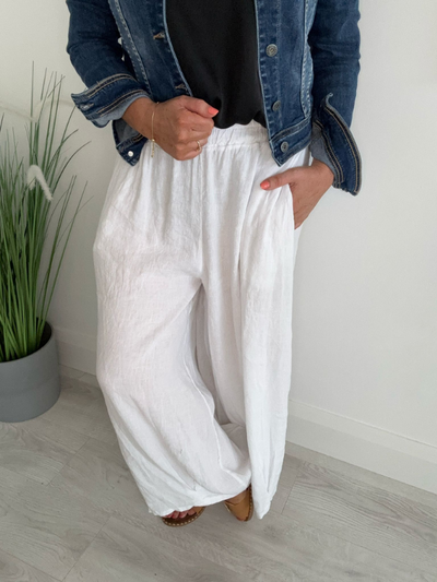 Model wearing 100% Linen Wide-Leg Pants with an elastic waist, styled for relaxed summer comfort
