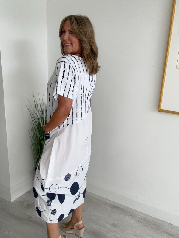 Model wearing White cotton midi dress with navy polka dots and stripes – one size fits 8–18