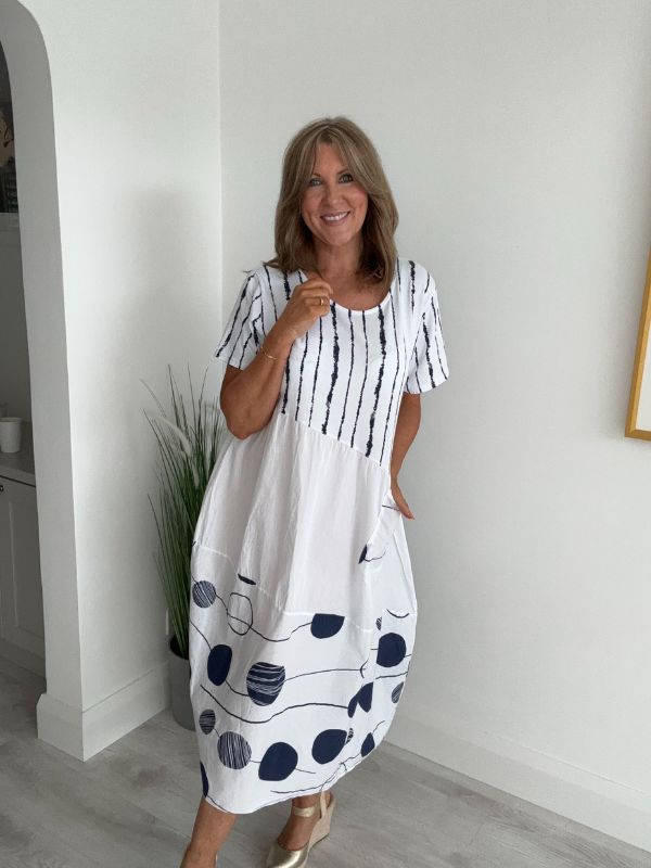 Model wearing White cotton midi dress with navy polka dots and stripes – one size fits 8–18