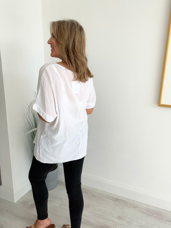 Brushed cotton and linen embroidered top with short sleeves and relaxed fit, displayed flat on neutral background