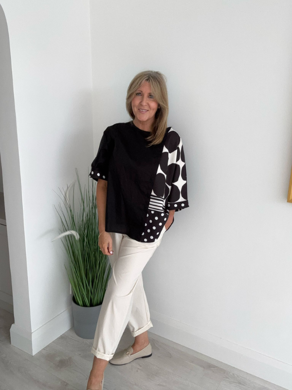 Plus size oversized blouse with polka dots and stripes, featuring asymmetric sleeves and modern abstract prints