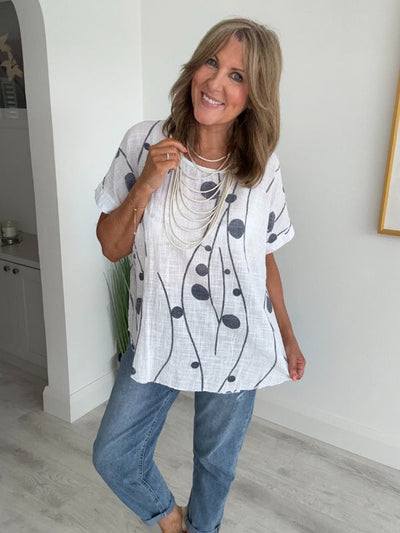 Women’s cotton half sleeve top with rolled cuffs, featuring a relaxed fit and abstract dot and vine print, available in vibrant colours and UK sizes 8–20.