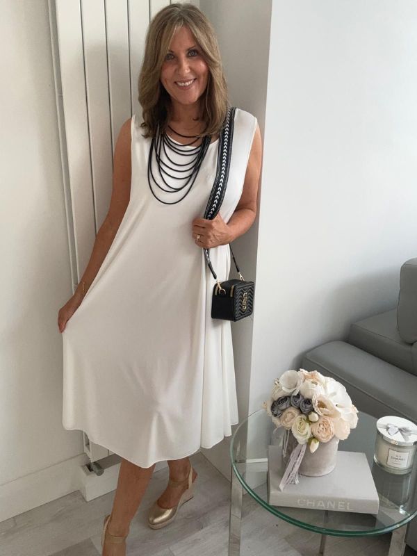 Plus-size women’s sleeveless swing midi dress in soft lightweight fabric, available in six colours including nude beige, hot pink, lavender purple, white, black, and taupe grey, designed for UK sizes 14–22.
